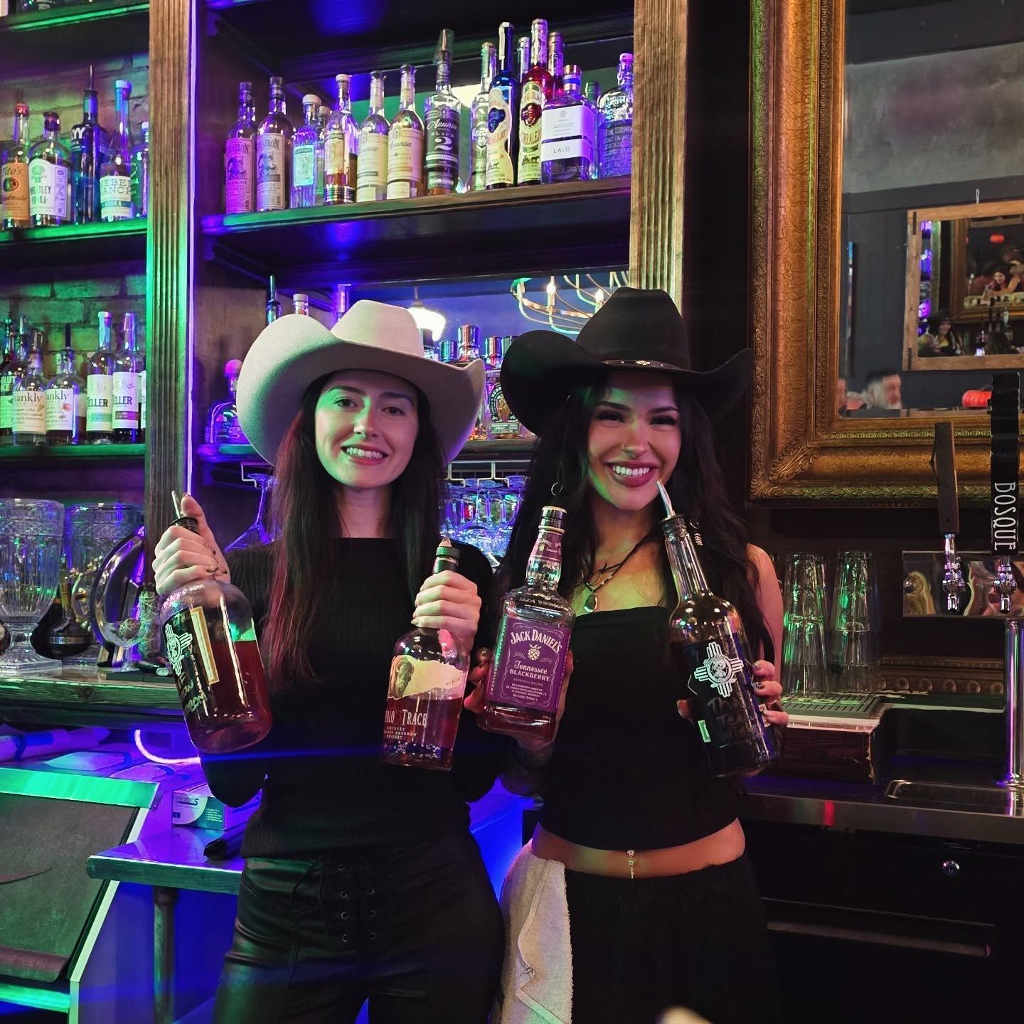 Borracho's bartenders behind the bar with a lineup of New Mexico spirits