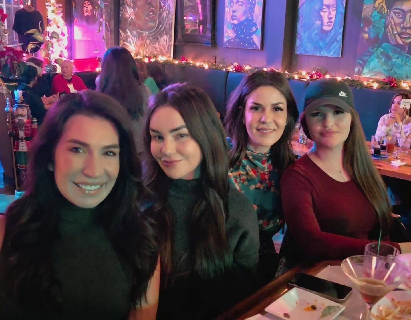 Four guests posing for a group photo at Borracho's