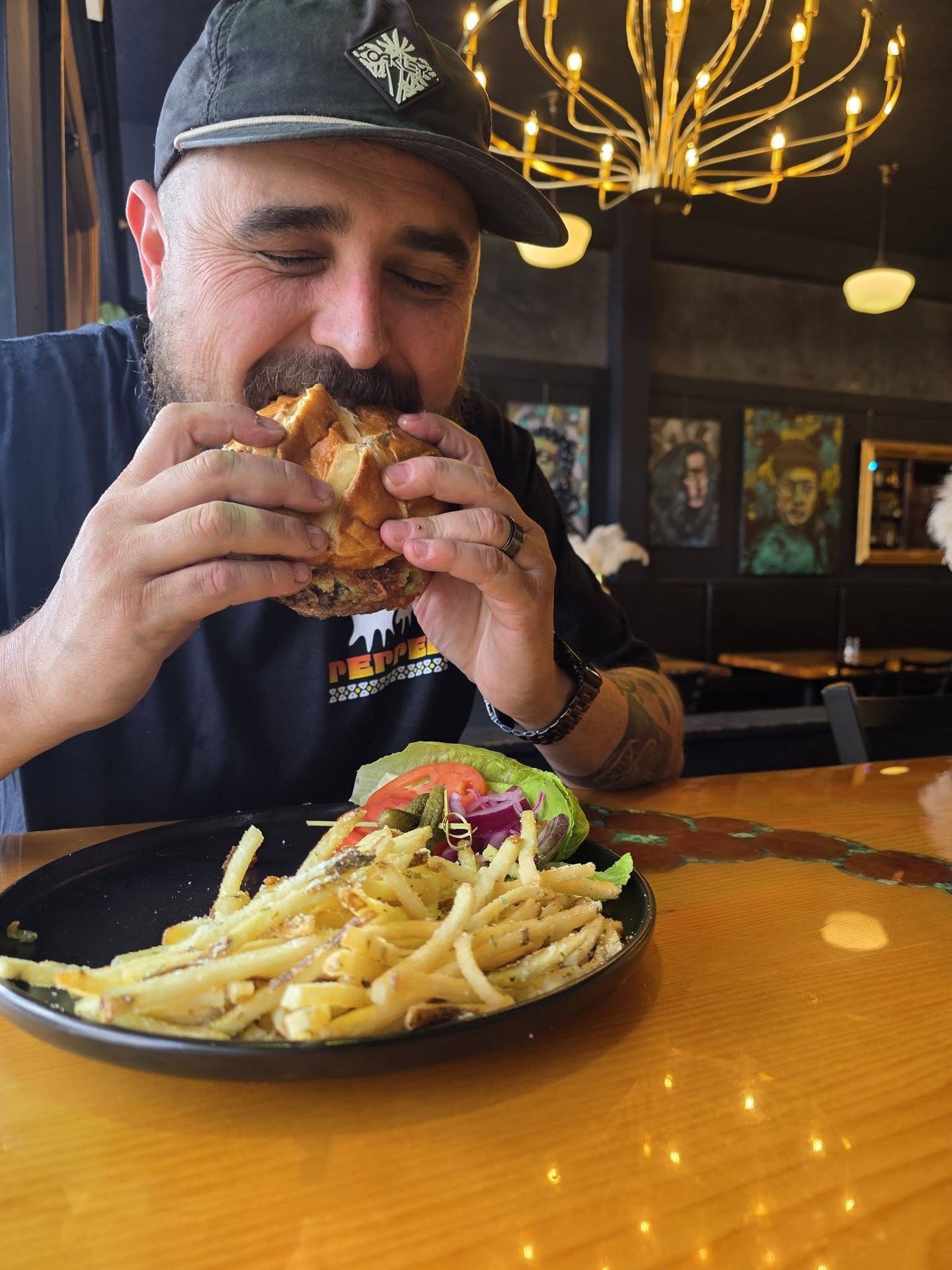 Ryan digging into a burger and fries at Borracho's